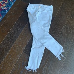 Slim white jeans with frayed cuffs